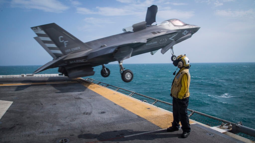 A Photo from Francisco Diaz of a Navy Sailor watching a F-35B Take off from the edge of a platform